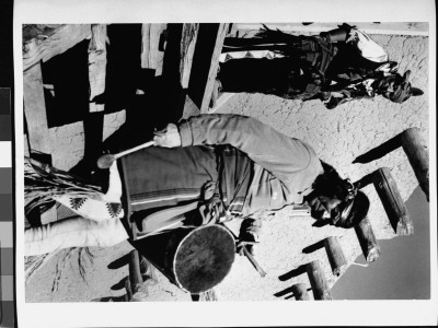 Dance, San Ildefonso Pueblo, New Mexico, 1942, Pueblo Indians At Adobe, One With A Drum by Ansel Adams Pricing Limited Edition Print image