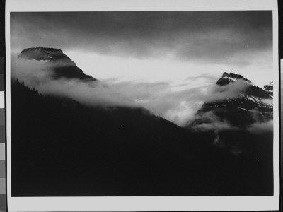 In Glacier National Park, Mysterious Cloudy Mountain Landscape At Glacier National Park by Ansel Adams Pricing Limited Edition Print image