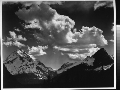 Cumulus Clouds Hovering Over Snow-Covered Mountain Landscape, At Glacier National Park by Ansel Adams Pricing Limited Edition Print image
