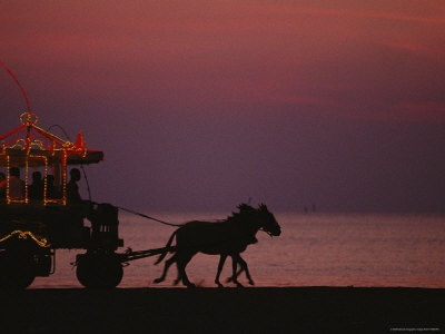 A Horse-Drawn Carriage Rolls Along Jeddahs Waterfront At Sunset by Reza Pricing Limited Edition Print image