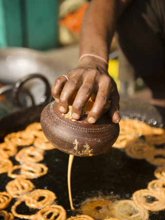 Man Frying Jalebis Batter To Make Sweets At Roadside Stall by Gavin Gough Pricing Limited Edition Print image