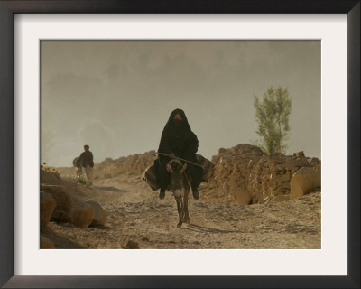 A Woman Rides A Donkey In Bamiyan Province, Central Afghanistan, September 16, 2005 by Tomas Munita Pricing Limited Edition Print image