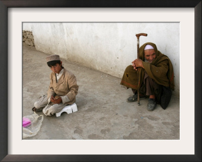 A Young Afghan Vendor Sells Toilet Paper At A Mosque by Rodrigo Abd Pricing Limited Edition Print image
