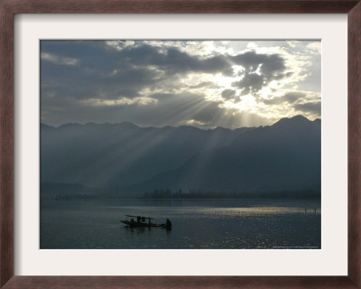 A Kashmiri Fisherman Rows His Boat At Dawn On The Dal Lake, Srinagar, India, Tuesday, April 5, 2005 by Rafiq Maqbool Pricing Limited Edition Print image