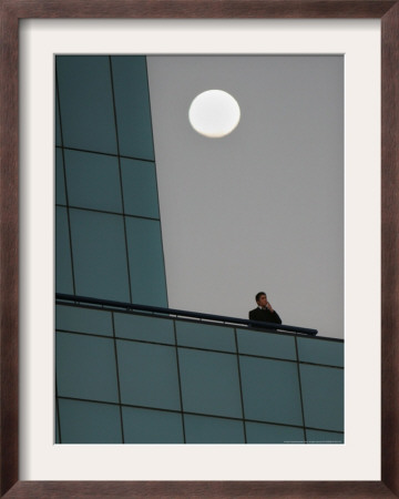 The Moon Rises As A Smoker Has A Cigarette On The Balcony, Johannesburg, Monday August 7, 2006 by Denis Farrell Pricing Limited Edition Print image