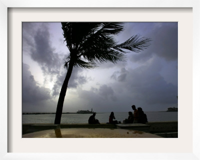 Visitors Sit By The Sea In Bombay, India, July 16, 2006 by Gurinder Osan Pricing Limited Edition Print image