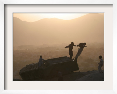Children Play On Top Of A Destroyed Tank by Rodrigo Abd Pricing Limited Edition Print image