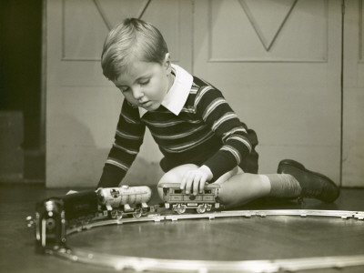 Young Boy Playing With Toy Trains by George Marks Pricing Limited Edition Print image