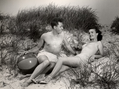 Couple Relaxing On Dunes At Beach by George Marks Pricing Limited Edition Print image