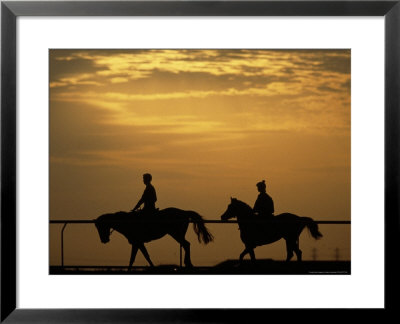 Silhouetted Men Riding On Horses, Dubai, Uae by Henry Horenstein Pricing Limited Edition Print image