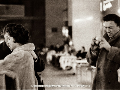 Federico Fellini Taking A Picture Of Anna Filippini, Roma, November 1957 by Benno Graziani Pricing Limited Edition Print image