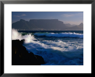 Wave Crashing On Rocks With Table Mountain In Distance, Cape Town, South Africa by Carol Polich Pricing Limited Edition Print image