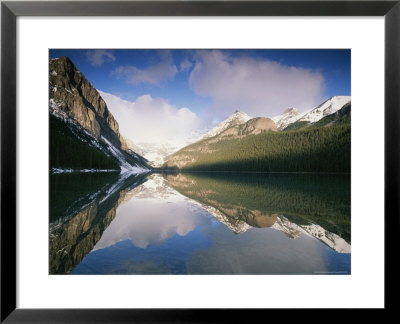 View At Sunrise Of Mountains Reflected On The Surface Of Lake Louise by Rich Reid Pricing Limited Edition Print image