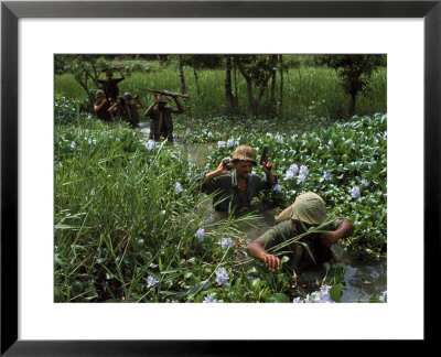 American Soldiers Wade Through Marshy Area During The Vietnam War by Paul Schutzer Pricing Limited Edition Print image