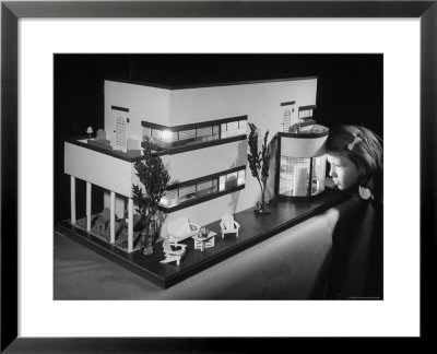 Little Girl Looking Into A Modern Doll House Being Sold At F.A.O. Schwarz by Herbert Gehr Pricing Limited Edition Print image