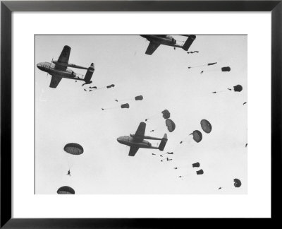 Scores Of Paratroopers Dropping From C-82 Flying Boxcar And Landing On Level Ground by Frank Scherschel Pricing Limited Edition Print image