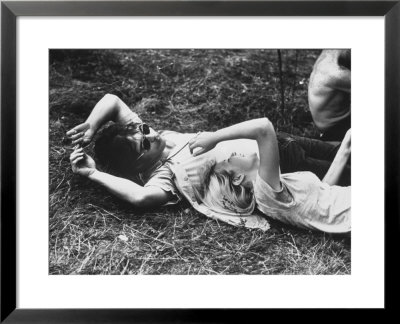 Young Couple Relaxing During Woodstock Music Festival by Bill Eppridge Pricing Limited Edition Print image