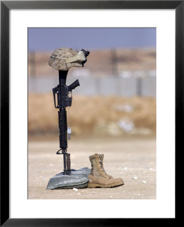 Boots, Rifle, Dog Tags, And Protective Helmet Stand In Solitude To Honor Fallen Soldiers by Stocktrek Images Pricing Limited Edition Print image
