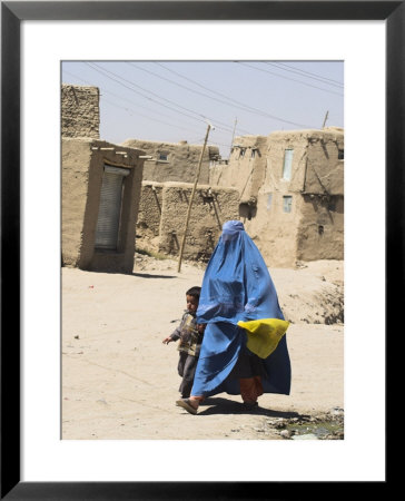 Lady Wearing Burqa Walks Past Houses Within The Ancient Walls Of The Citadel, Ghazni, Afghanistan by Jane Sweeney Pricing Limited Edition Print image