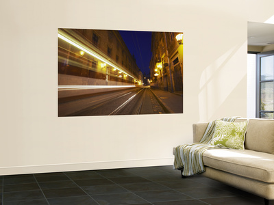Tram Passing Along Ruska Street At Dusk, Lviv, Ukraine by Ian Trower Pricing Limited Edition Print image