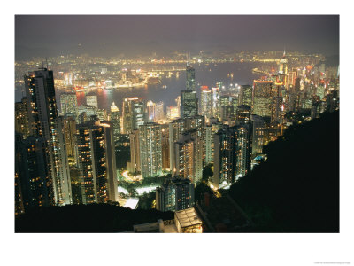 The Hong Kong Skyline Is Lit Up At Night With Thousands Of Lights by Paul Chesley Pricing Limited Edition Print image