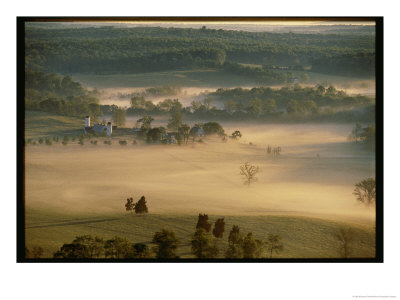Aerial View Of A Farm And Surrounding Landscape Covered In Fog by Kenneth Garrett Pricing Limited Edition Print image