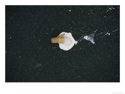 A Scoop Of Vanilla Ice Cream In A Cone Melts On Asphalt Pavement by Jodi Cobb Pricing Limited Edition Print image