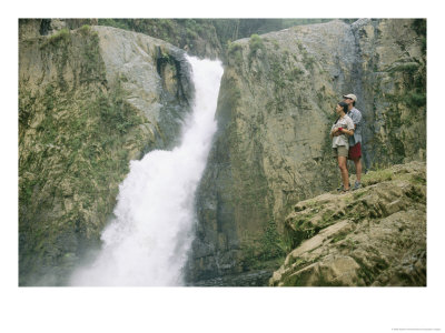 A Couple Enjoys A Waterfall In The Dominican Republic by Stephen Alvarez Pricing Limited Edition Print image