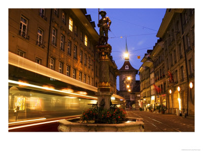 Moving Tram On Marktgasse With Zeitglockenturm Behind, Bern, Switzerland by Glenn Beanland Pricing Limited Edition Print image