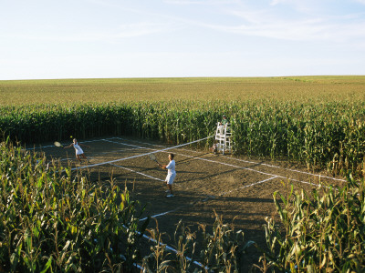 An Umpire Watches A Game On A Tennis Court Carved From A Cornfield by Joel Sartore Pricing Limited Edition Print image
