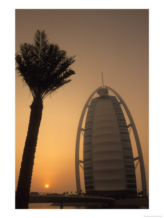 Palm Tree Next To Burj Al Arab Hotel At Sunset, Dubai, United Arab Emirates by Holger Leue Pricing Limited Edition Print image