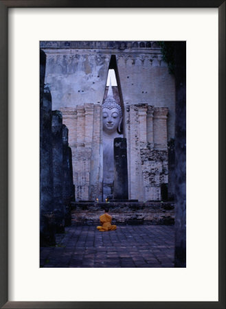 Monks Meditating In Front Of Large Buddha Statue At Wat Si Chum, Sukhothai, Thailand by Tom Cockrem Pricing Limited Edition Print image