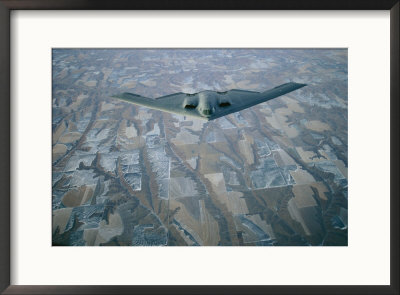 A B-2 Stealth Bomber Flies Above The Patterned Terrain Of Southwestern Nebraska by Joel Sartore Pricing Limited Edition Print image