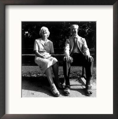 Mature Couple Sitting On A Bench Laughing by Kellie Walsh Pricing Limited Edition Print image