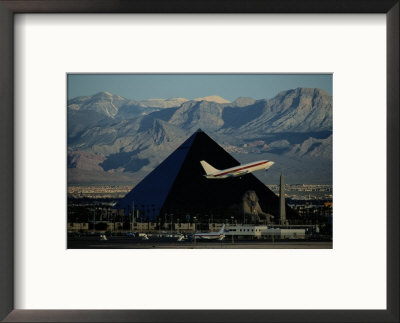 A Jet Flies Past The Luxor Hotel, The Worlds Fourth Largest Pyramid by Maria Stenzel Pricing Limited Edition Print image