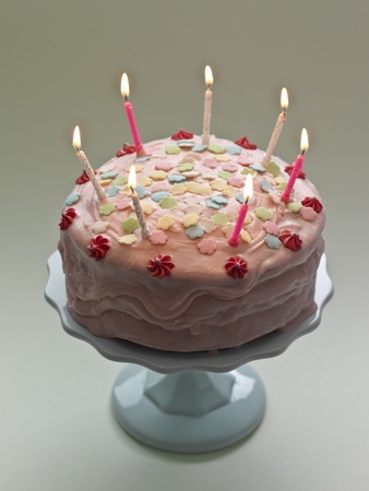 Birthday Cake With Candles Lit On Cakestand by Simon Brown Pricing Limited Edition Print image