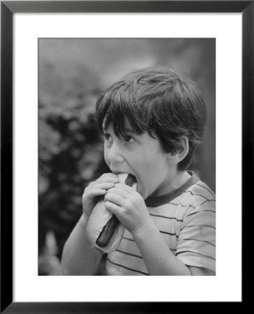 Boy Eating Hot Dog by Ralph Morse Pricing Limited Edition Print image