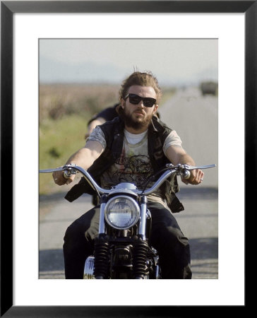 Member Of Hell's Angels Riding Motorcycle On Road by Bill Ray Pricing Limited Edition Print image