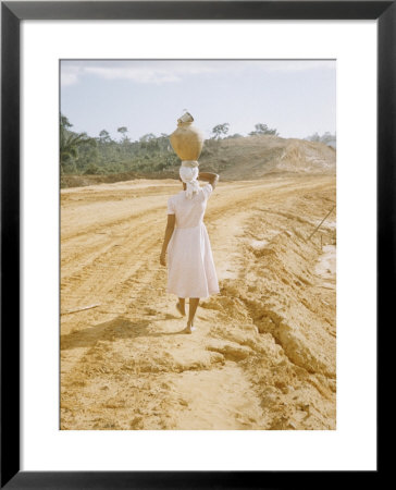 Brazilian Woman Walking Down A Sandy Road Carrying A Large Jar On Her Head by Dmitri Kessel Pricing Limited Edition Print image