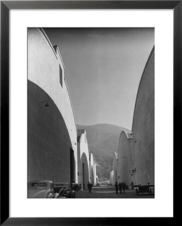 People Walking Between Sound Stages At Warner Bros. Studio by Margaret Bourke-White Pricing Limited Edition Print image