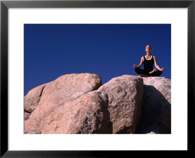 Yoga On The Rocks In The Joshua Tree National Park, California, Usa by Cheyenne Rouse Pricing Limited Edition Print image