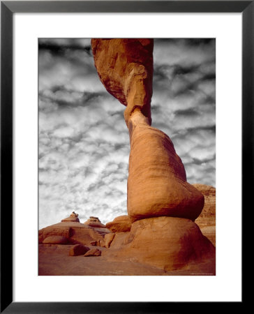 Portion Of Delicate Arch Against Clouds, Arches National Park, Utah, Usa by Jim Zuckerman Pricing Limited Edition Print image