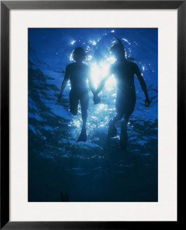 A Couple Swimming Hand-N-Hand, Silhouetted By Sunlight Above by Nick Caloyianis Pricing Limited Edition Print image
