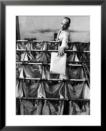 Man Sorting Mail In The State Dept. Building, Each Bag Is Labeled With Foreign City Destination by Alfred Eisenstaedt Pricing Limited Edition Print image