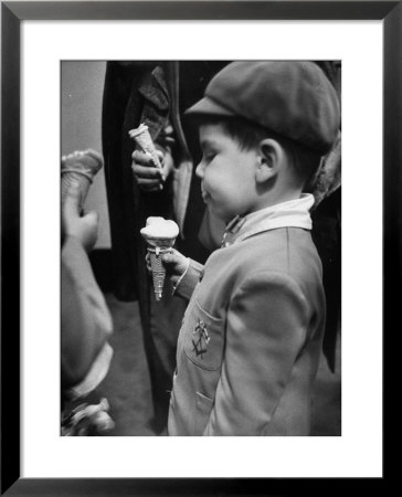 Boy Eating Ice Cream Cone At The Circus In Madison Square Garden by Cornell Capa Pricing Limited Edition Print image