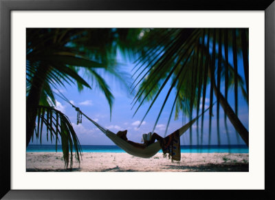 Woman In Hammock On Beach, Ari Atoll, Maldives by Stuart Westmoreland Pricing Limited Edition Print image