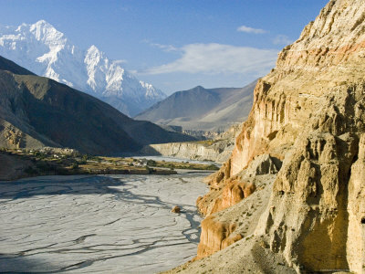 The Kali Gandaki Gorge In Mustang, With Nilgiri Peak And A Village by Stephen Sharnoff Pricing Limited Edition Print image
