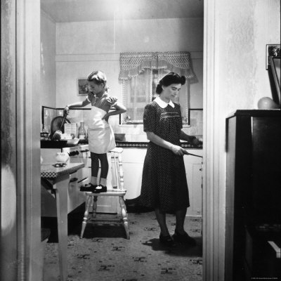 Child Actress Natalie Wood, Cooking In The Kitchen With Her Mother Mrs. Nick Gurdin by Martha Holmes Pricing Limited Edition Print image
