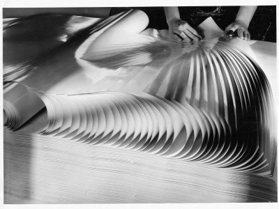 Inspector Fanning Sheets Of Finished Paper While Checking For Flaws At Oxford Paper Mill by Margaret Bourke-White Pricing Limited Edition Print image