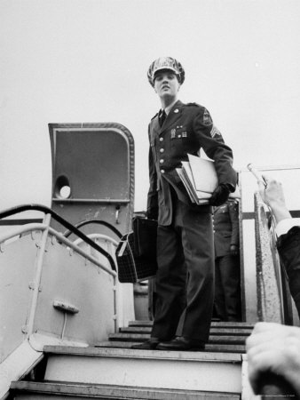 Elvis Presley In Uniform, Standing On Stairway Of Airplane, Prepares To Return Home by James Whitmore Pricing Limited Edition Print image